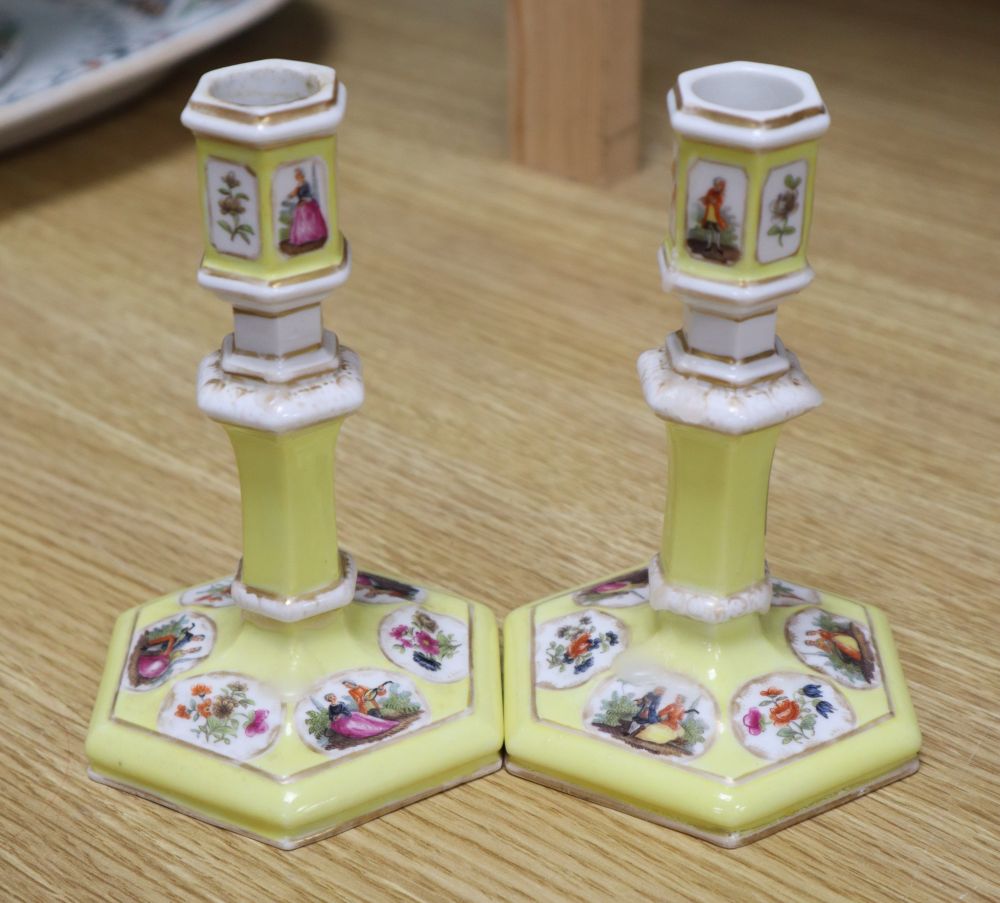 A pair of Berlin yellow ground porcelain candlesticks, height 14cm